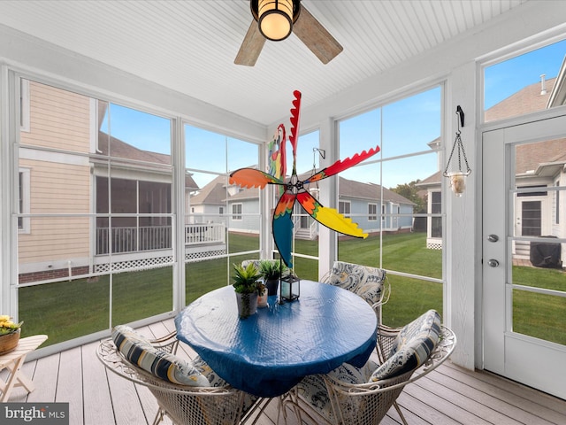 sunroom featuring ceiling fan