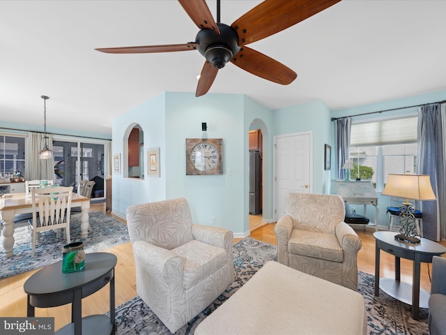 living room featuring ceiling fan and light hardwood / wood-style flooring