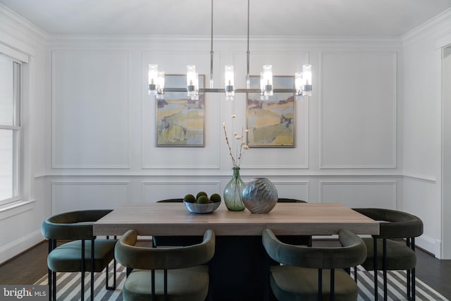 dining space featuring ornamental molding and dark hardwood / wood-style floors