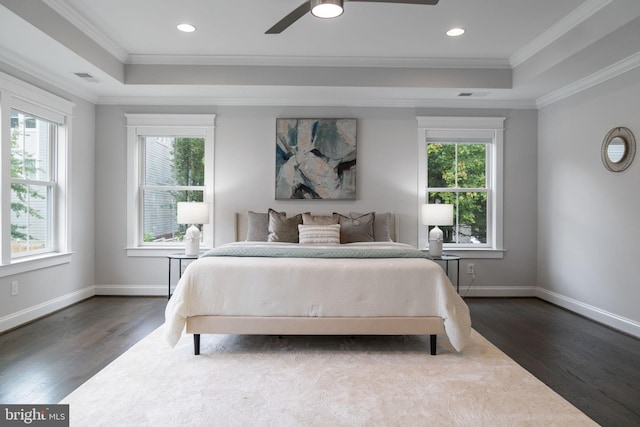 bedroom with ornamental molding, multiple windows, and dark hardwood / wood-style floors