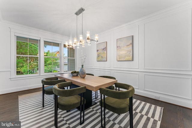 dining area featuring crown molding, dark hardwood / wood-style flooring, and a chandelier