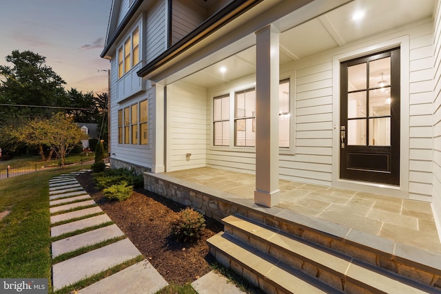 exterior entry at dusk with a porch