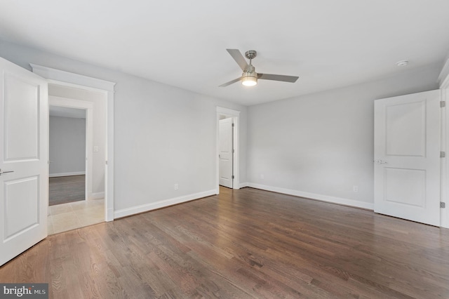 interior space with ceiling fan and dark wood-type flooring