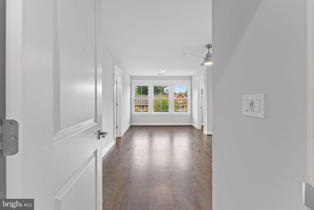 empty room with ceiling fan and dark hardwood / wood-style flooring