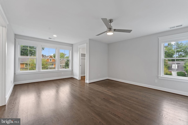 unfurnished living room featuring dark hardwood / wood-style floors and ceiling fan