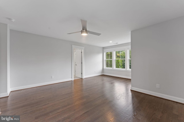 empty room featuring dark wood-type flooring and ceiling fan