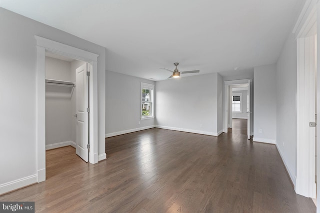 interior space with a closet, ceiling fan, and dark hardwood / wood-style flooring