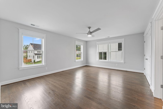 spare room featuring ceiling fan and dark hardwood / wood-style floors