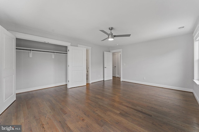 unfurnished bedroom with a closet, ceiling fan, and dark hardwood / wood-style flooring