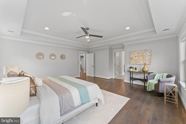 bedroom with crown molding, a tray ceiling, dark hardwood / wood-style flooring, and ceiling fan