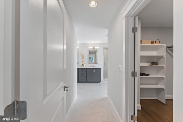 hallway featuring hardwood / wood-style flooring and sink