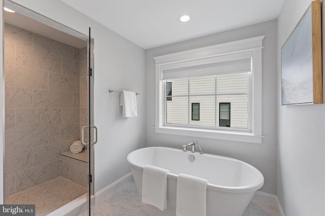 bathroom featuring shower with separate bathtub and plenty of natural light