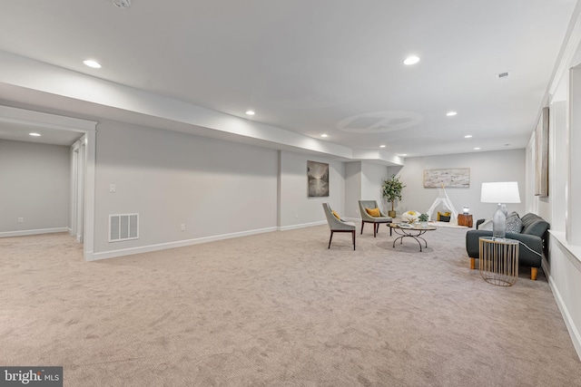 living area featuring light carpet