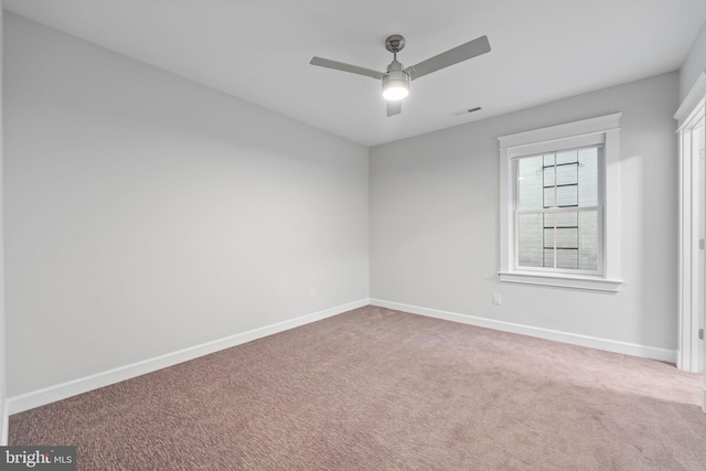 unfurnished room with carpet and ceiling fan