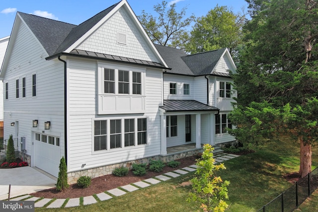 view of front facade with a front lawn, a porch, and a garage