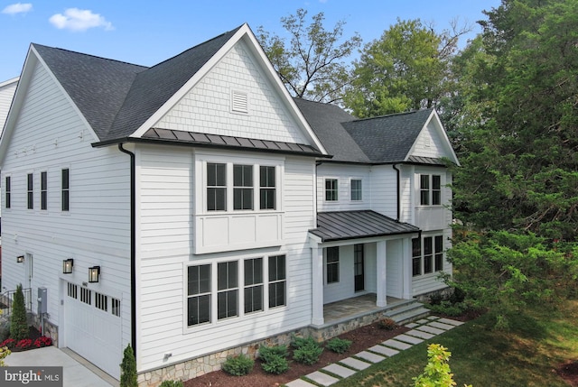 view of front of property with covered porch and a garage