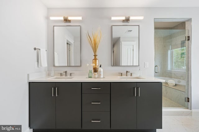 bathroom with vanity and a shower with shower door