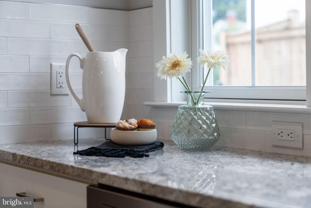 details featuring decorative backsplash and light stone counters