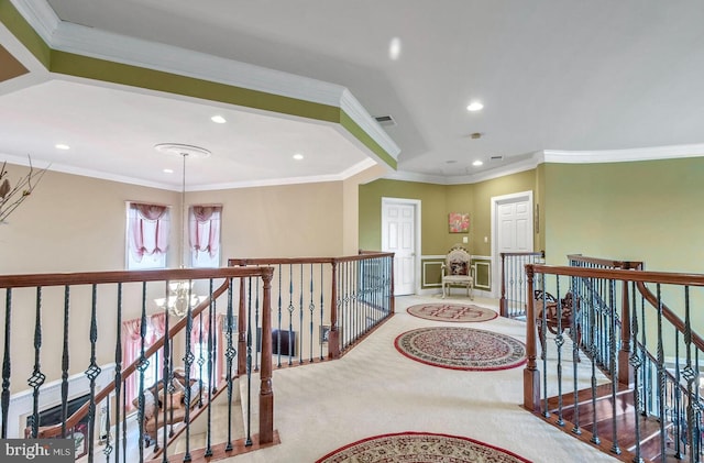 hall featuring crown molding, carpet, and a notable chandelier