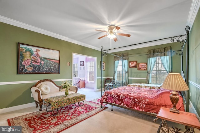 carpeted bedroom with ceiling fan and ornamental molding