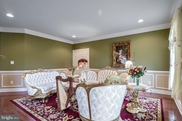 sitting room with dark wood-type flooring and crown molding