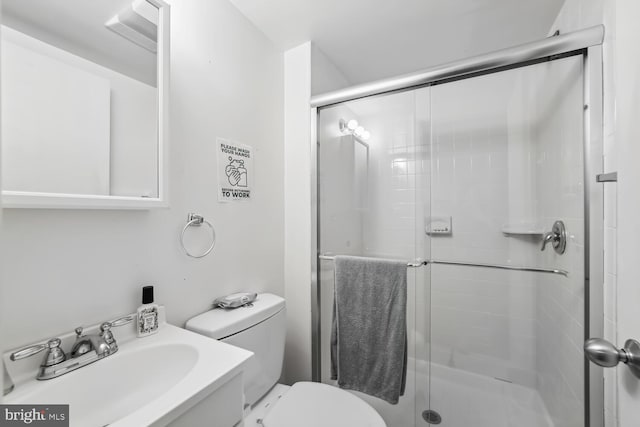 bathroom featuring vanity, an enclosed shower, and toilet