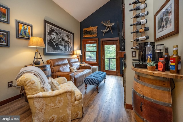 sitting room with vaulted ceiling and hardwood / wood-style floors