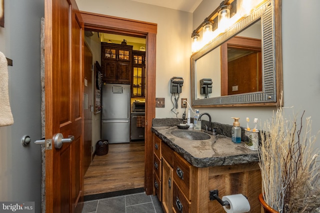 bathroom with vanity and hardwood / wood-style floors