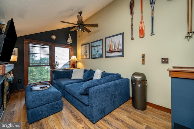 living room featuring ceiling fan, wood-type flooring, and lofted ceiling