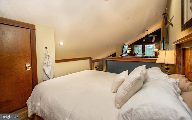 bedroom with wood-type flooring and vaulted ceiling