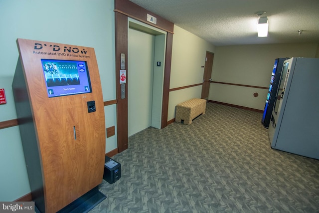 corridor with elevator and a textured ceiling