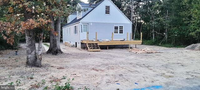 back of house featuring a wooden deck