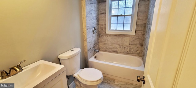 full bathroom with vanity, tiled shower / bath combo, and toilet