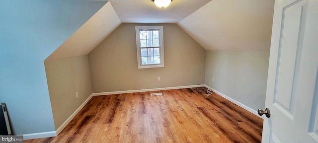 bonus room featuring hardwood / wood-style flooring and lofted ceiling