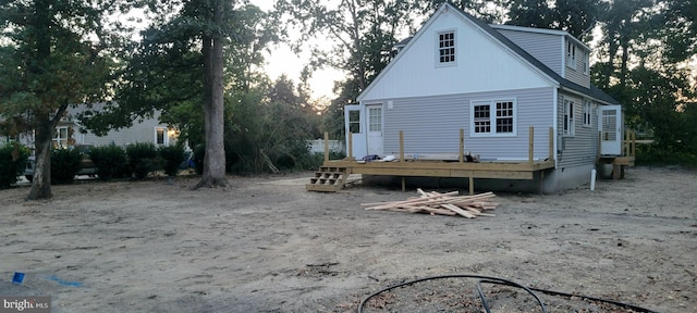 back of property with a wooden deck