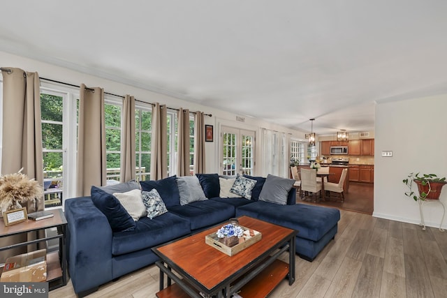 living room featuring french doors and light wood-type flooring