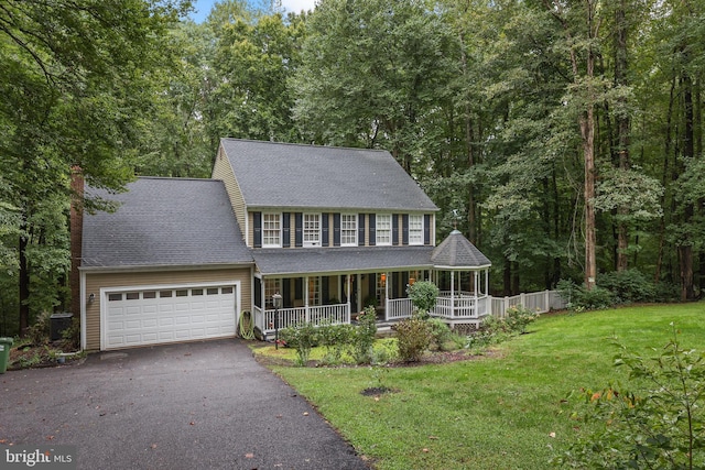 colonial-style house with a front lawn and a porch