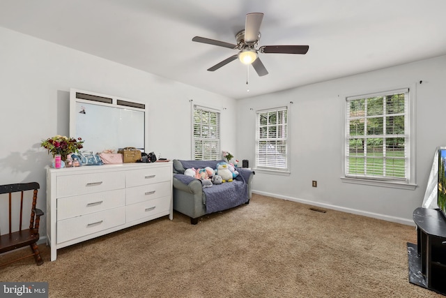 sitting room with ceiling fan and carpet floors