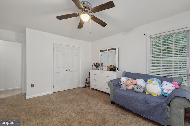 sitting room featuring ceiling fan and carpet floors