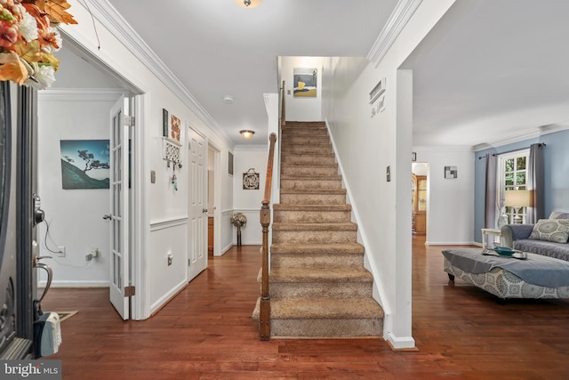 stairway featuring wood-type flooring and crown molding