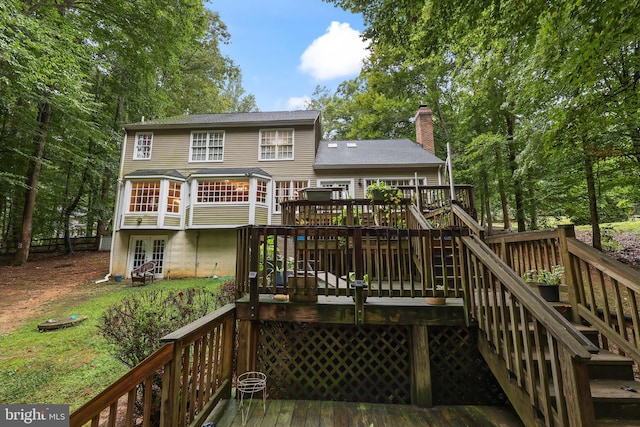 back of house featuring a wooden deck