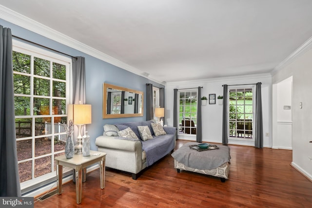 living room with ornamental molding and dark hardwood / wood-style floors