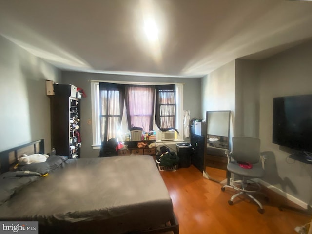 bedroom with hardwood / wood-style floors