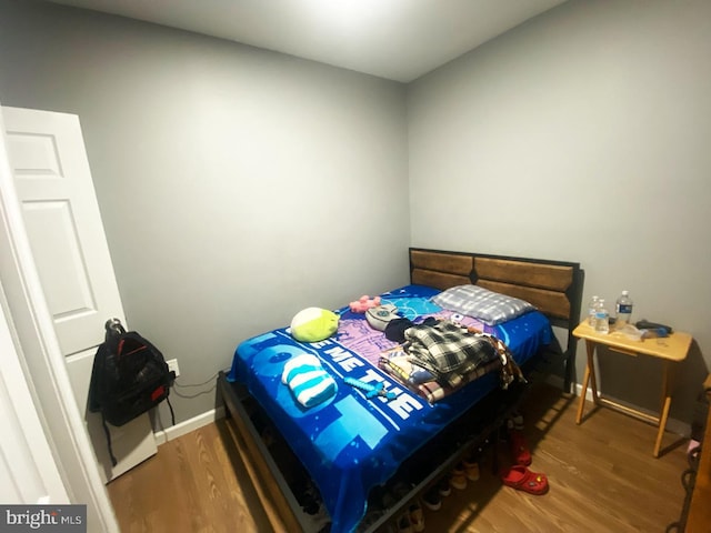 bedroom with hardwood / wood-style flooring