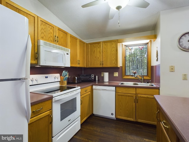 kitchen with ceiling fan, sink, dark hardwood / wood-style flooring, vaulted ceiling, and white appliances