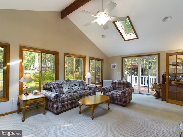 carpeted living room featuring beam ceiling, high vaulted ceiling, and a healthy amount of sunlight