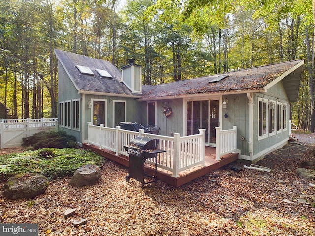 back of house featuring a wooden deck