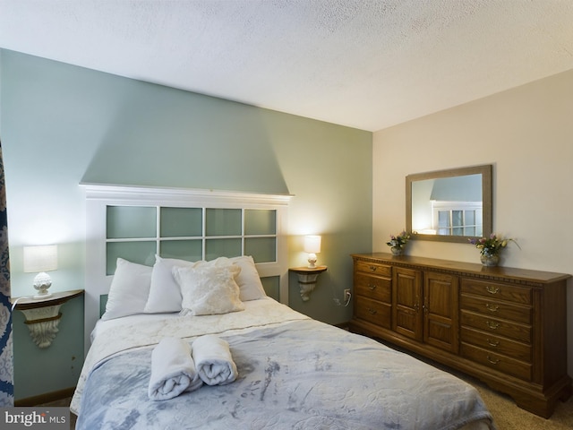 bedroom featuring a textured ceiling and carpet floors