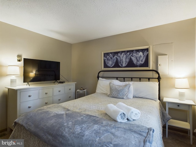 carpeted bedroom featuring a textured ceiling