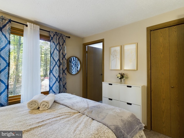 carpeted bedroom featuring a textured ceiling